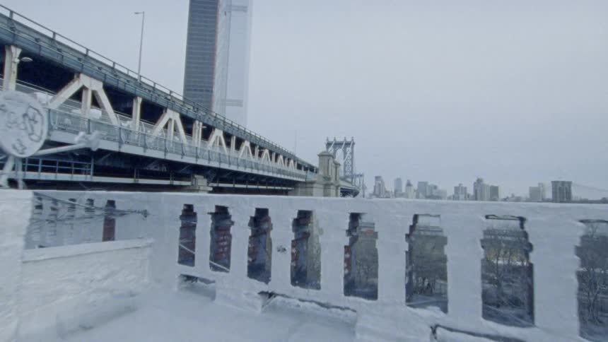A bridge and park being viewed from a rooftop