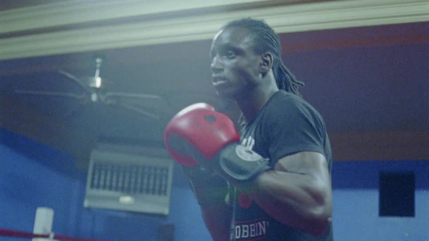 Two people are fighting in a boxing ring