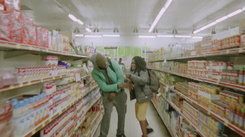 Two people play fight in the grocery store