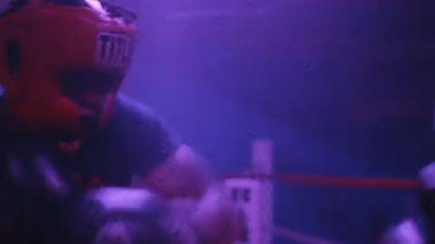 Two men box in a boxing ring