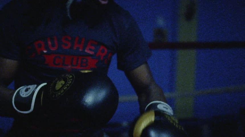 Two rival boxers throw punches at one another during boxing match
