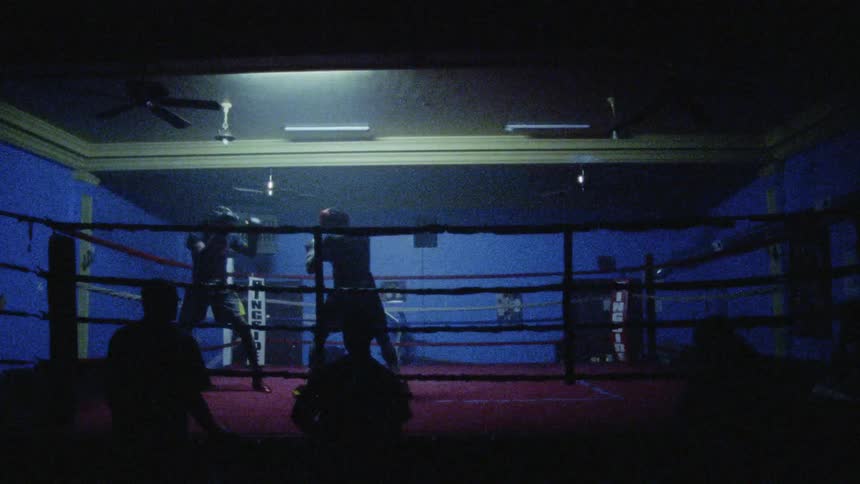 Lights flash over a boxing match