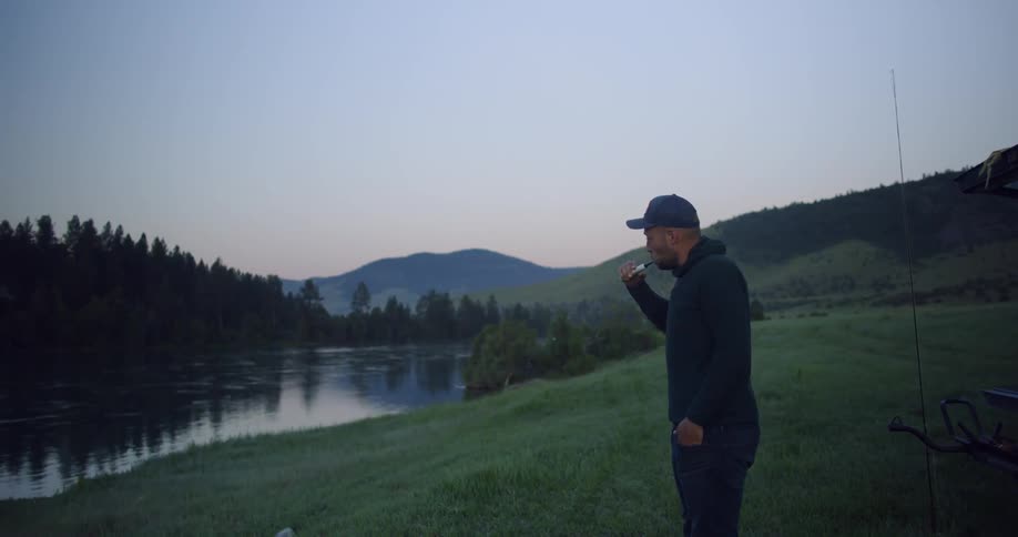 A man brushing his teeth outdoors