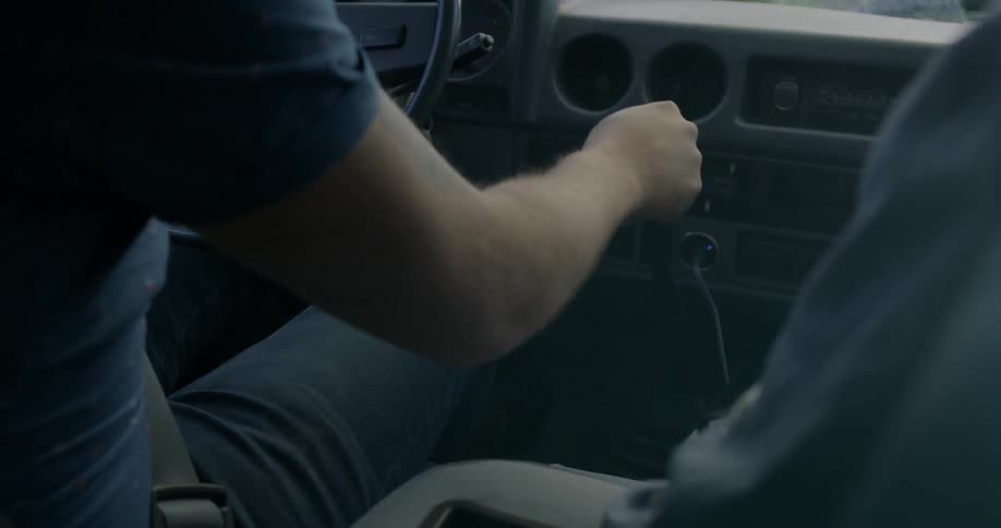 A man shifts gears in a manual car