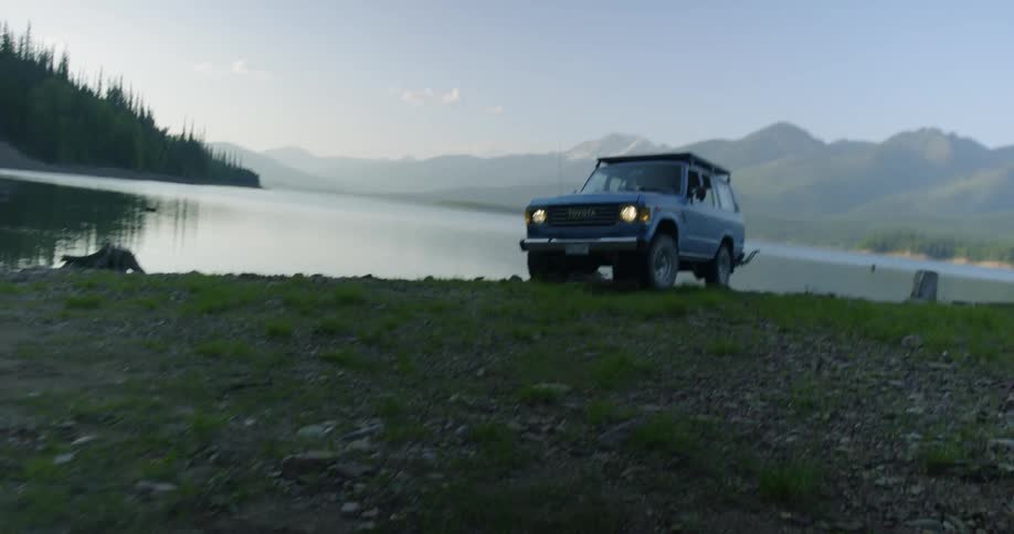 Vehicle backs up towards the lake