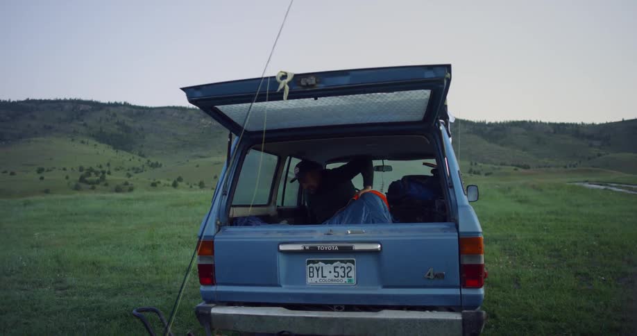 A man sitting inside a truck in a field