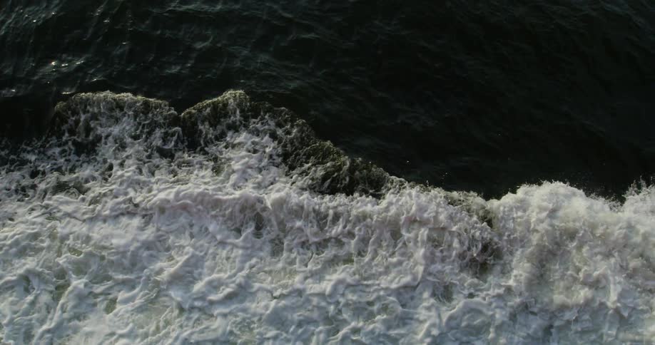 The rough waves crash against the shore