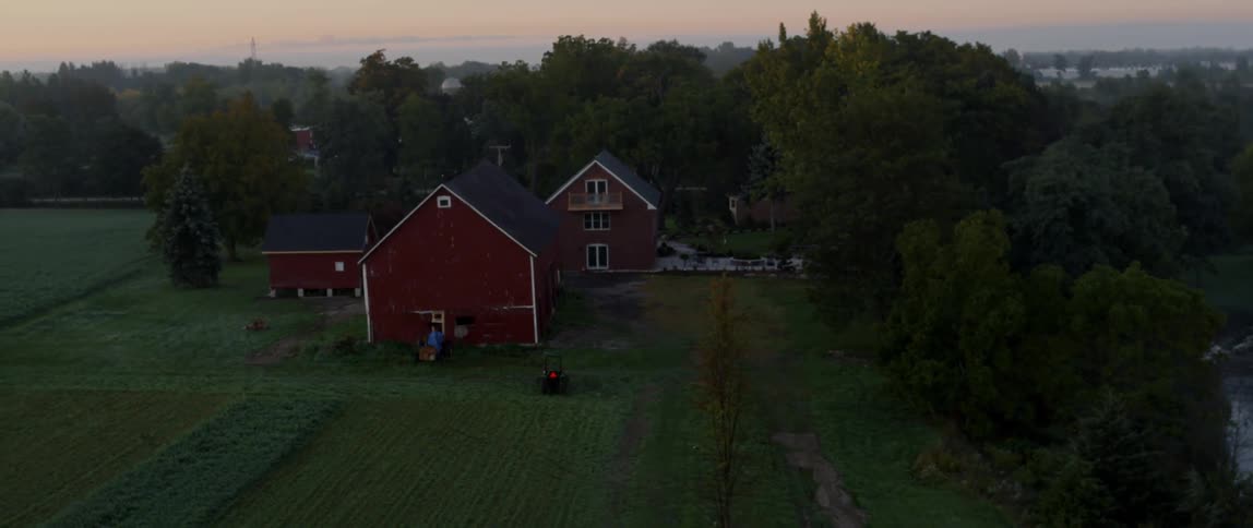 A red barn is in a remote area