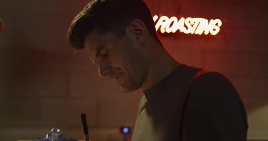 A man is taking notes on a clipboard