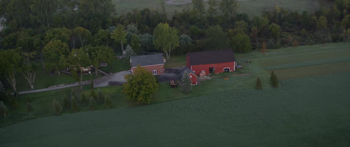 A house and a barn are on a plot of land