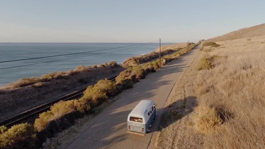 A car is driving down the road