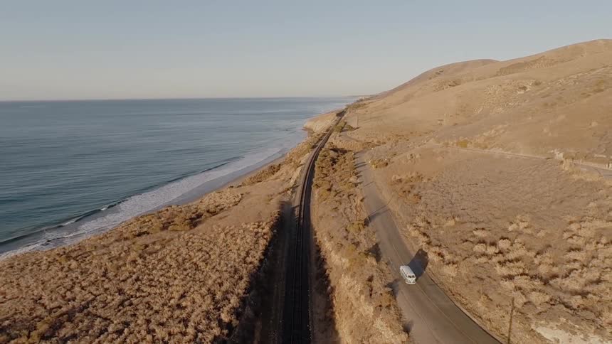 A car is driving down the road