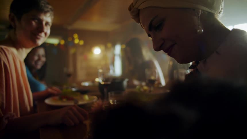 A group of people eat a meal together at a restaurant