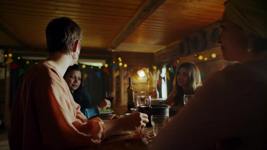 Women sitting at a table and chatting while drinking wine