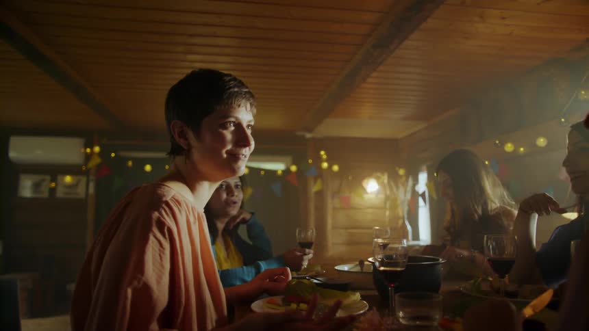 Friends talk while eating at a dinner party