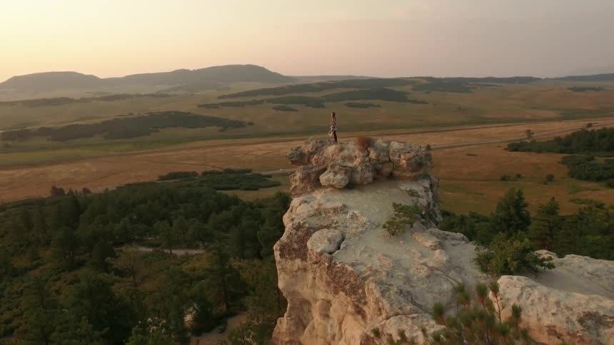 A person standing on a cliff edge