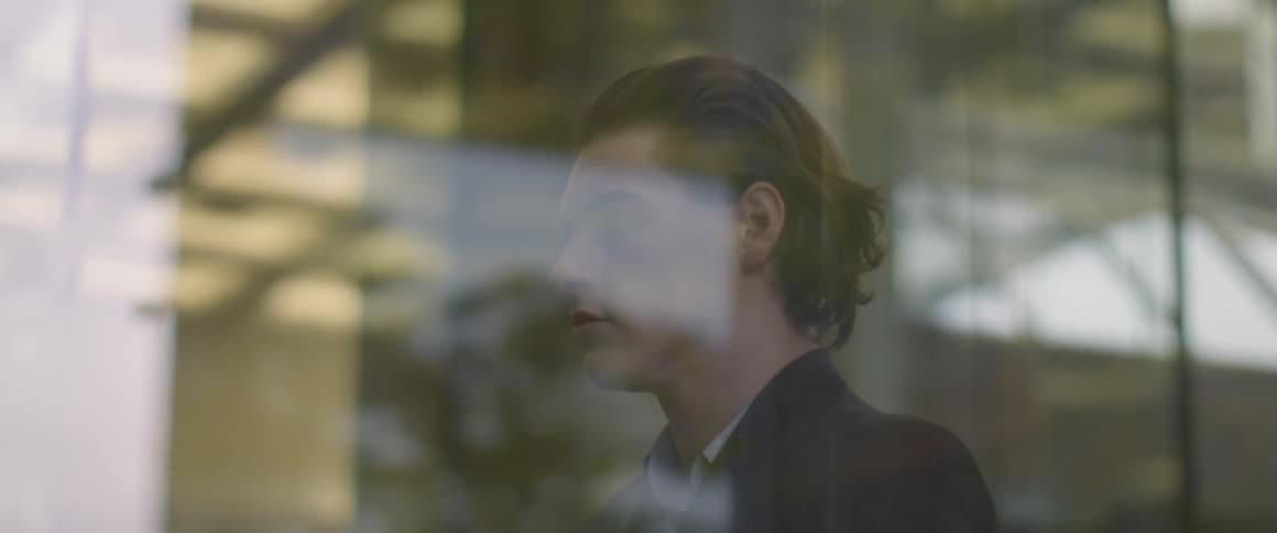 A man is looking out a window