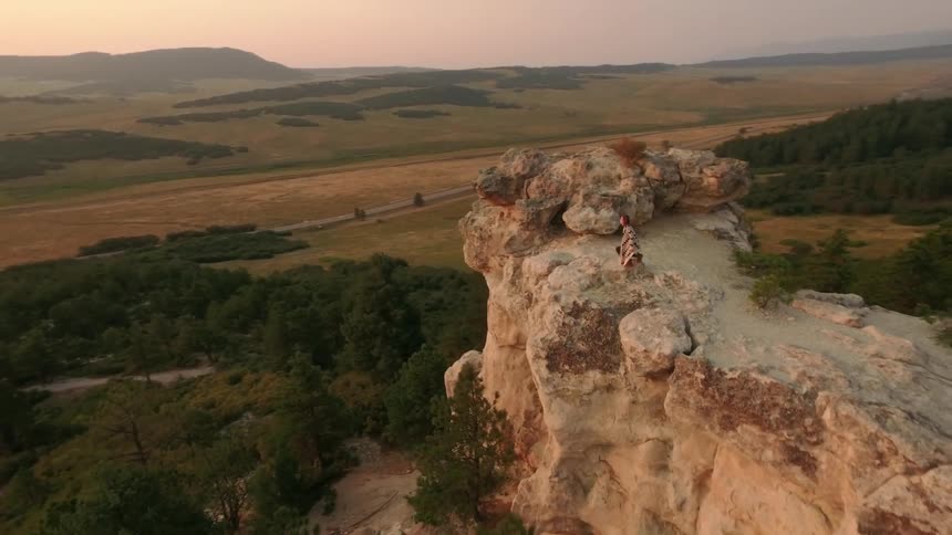 A person standing on a cliff edge