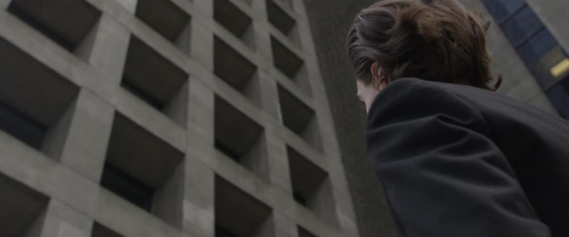A man looks up at the tall building