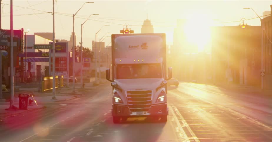 A truck passes through a junction at sunset