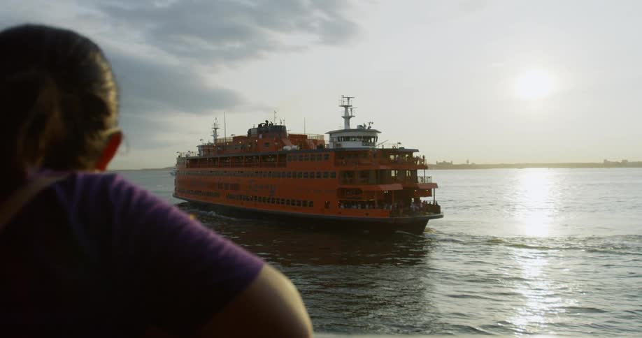 A man watches a large boat cruise away