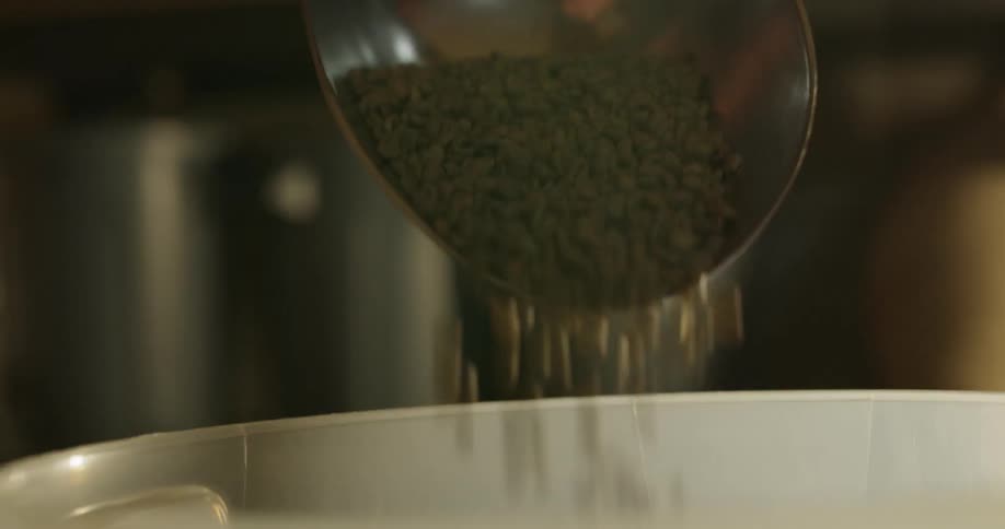 A scoop pouring objects into a container