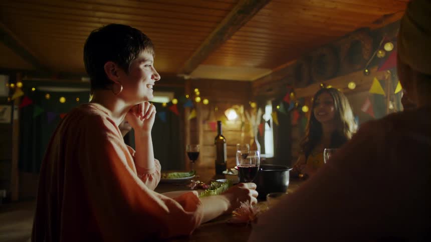 Friends talk while eating at a dinner party
