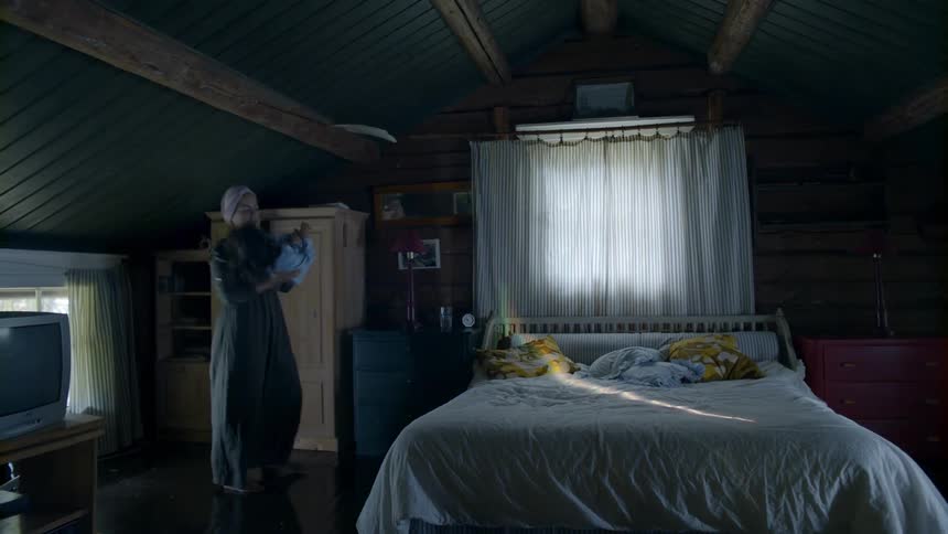 A mother plays with her daughter in a bedroom