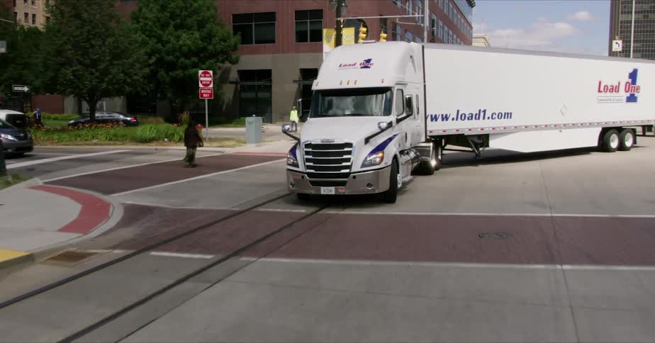 Large 18-wheeler drives in city