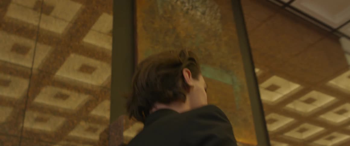 Young man walking through the lobby of a building