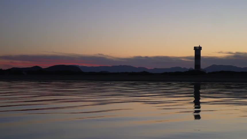 A tower overlooking a calm body of water