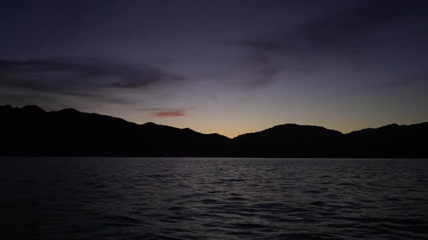 Waves flow in the lake under the night sky