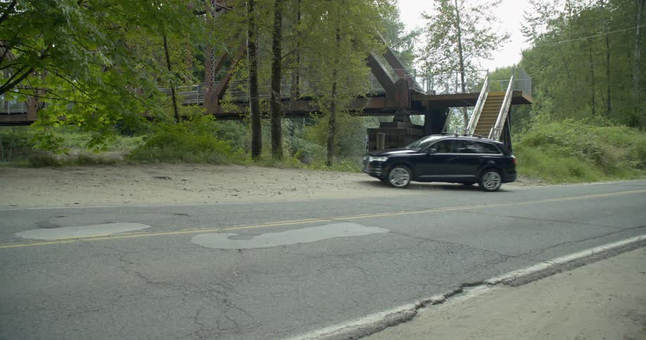 A car is driving outside then parks the car