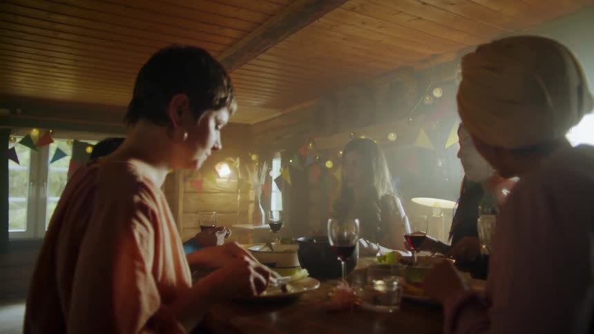 Several people are talking while eating together