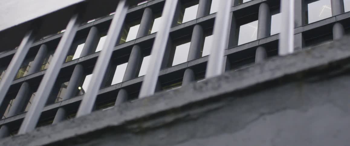 The railing is near the tall building