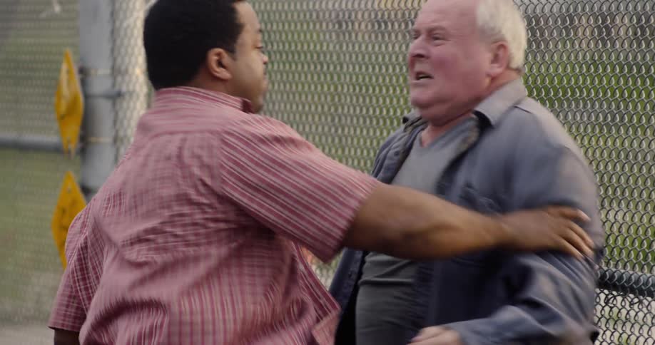 Two men physically punching grabbing and fighting each other