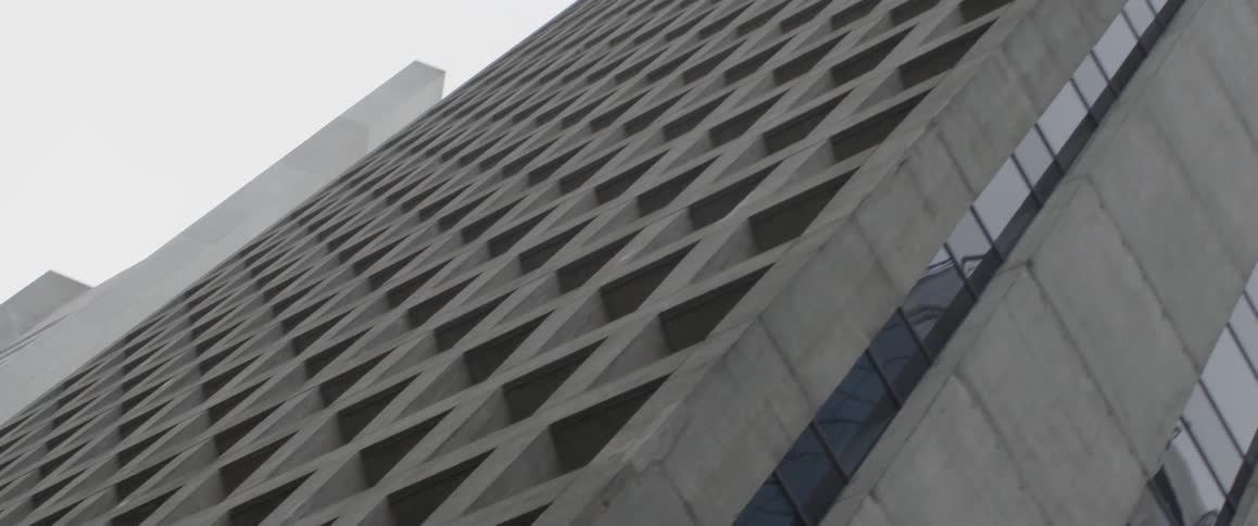 The tall building has a line of windows on the side