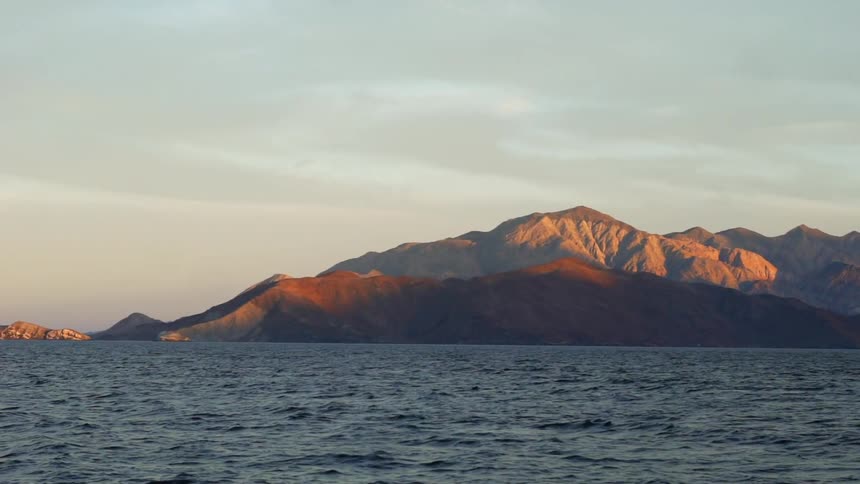 The waves are moving by the mountain side
