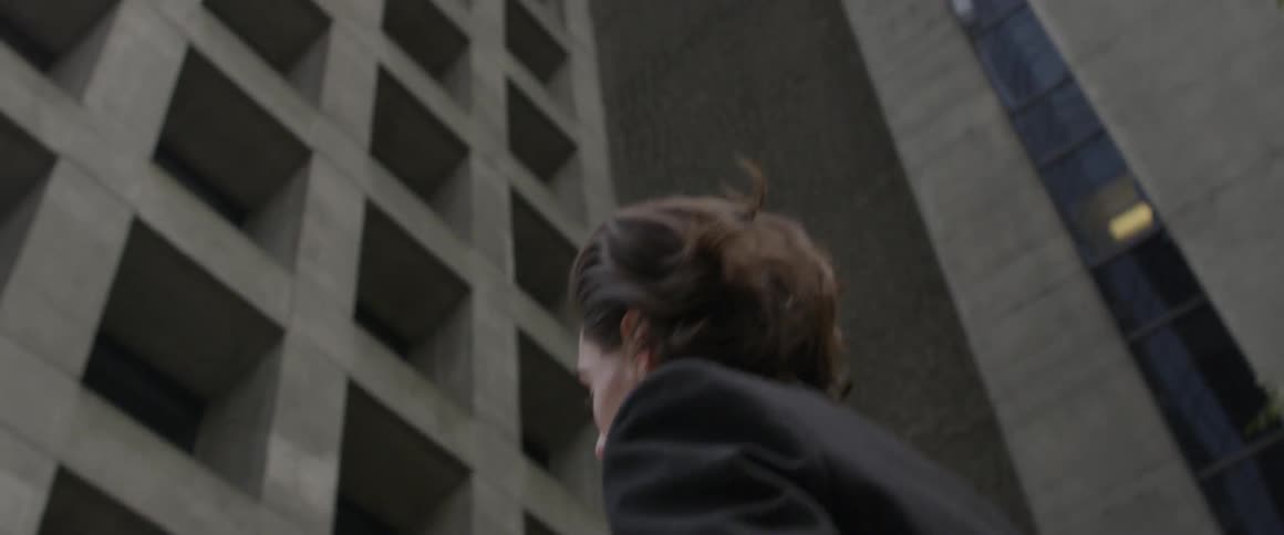 A man looking up at a skyscraper