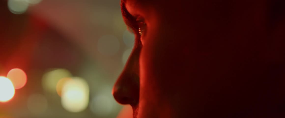 A person is looking outside at night blinking