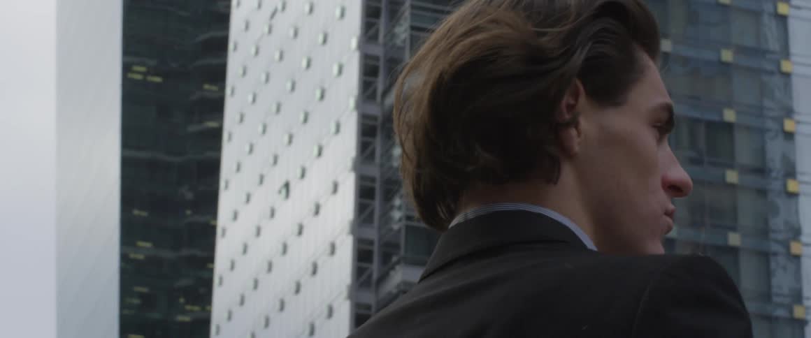 Man stands near buildings in city