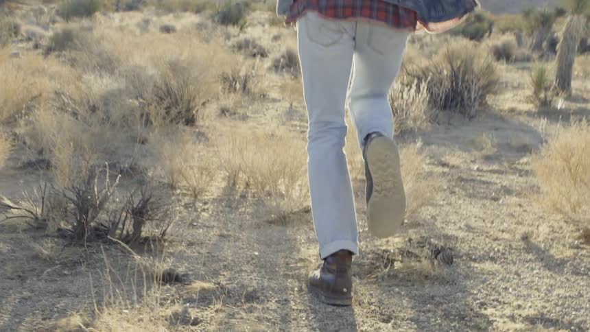 Man runs in the desert under the bright sun