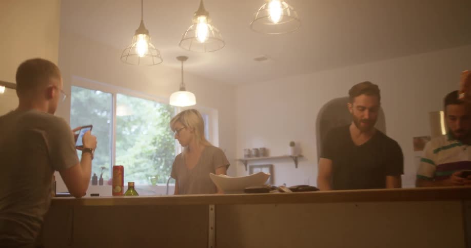 A group of people gathered in a kitchen