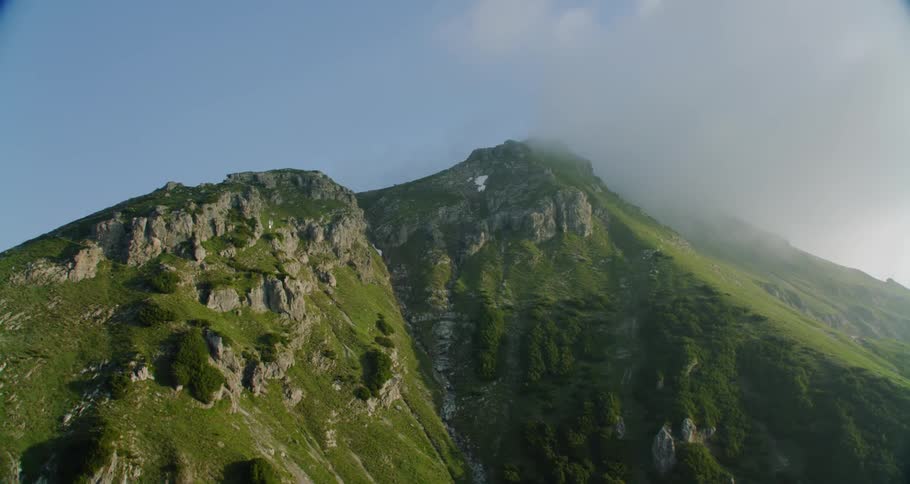 Tall mountains reaching clouds