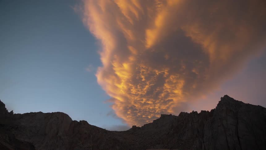 A cloud is shown over a mountain