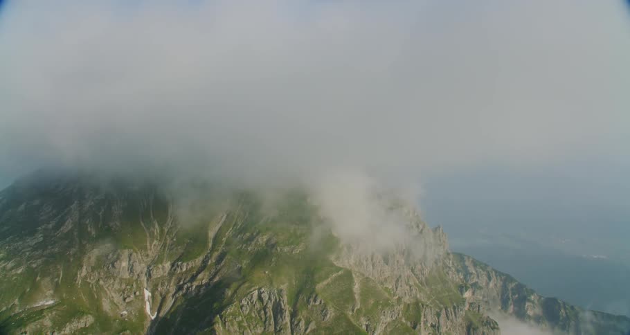Clouds surrounding a large mountain