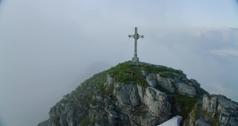 Very large cross on a rocky hilled mountain