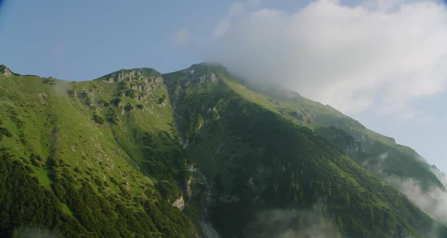 Clouds blow around a mountain top