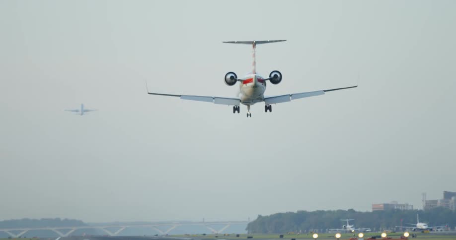 A jet plane lands on a runway