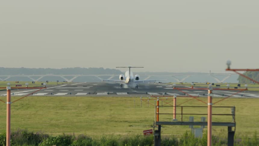 A jet plane lands on a runway